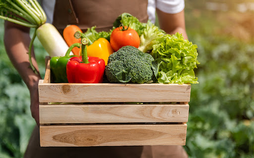 farmer holding a basket of high fiber vegetables