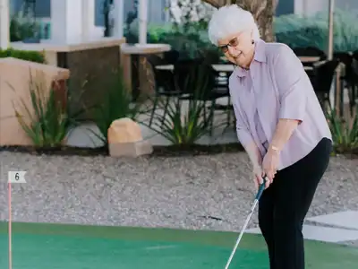 Lady golfing on the patio