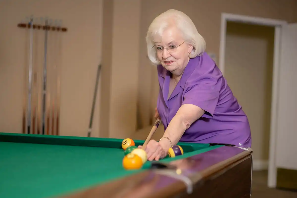 A lady playing billiards
