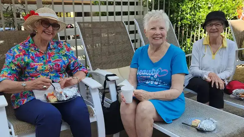 Ladies having breakfast by a swimming pool